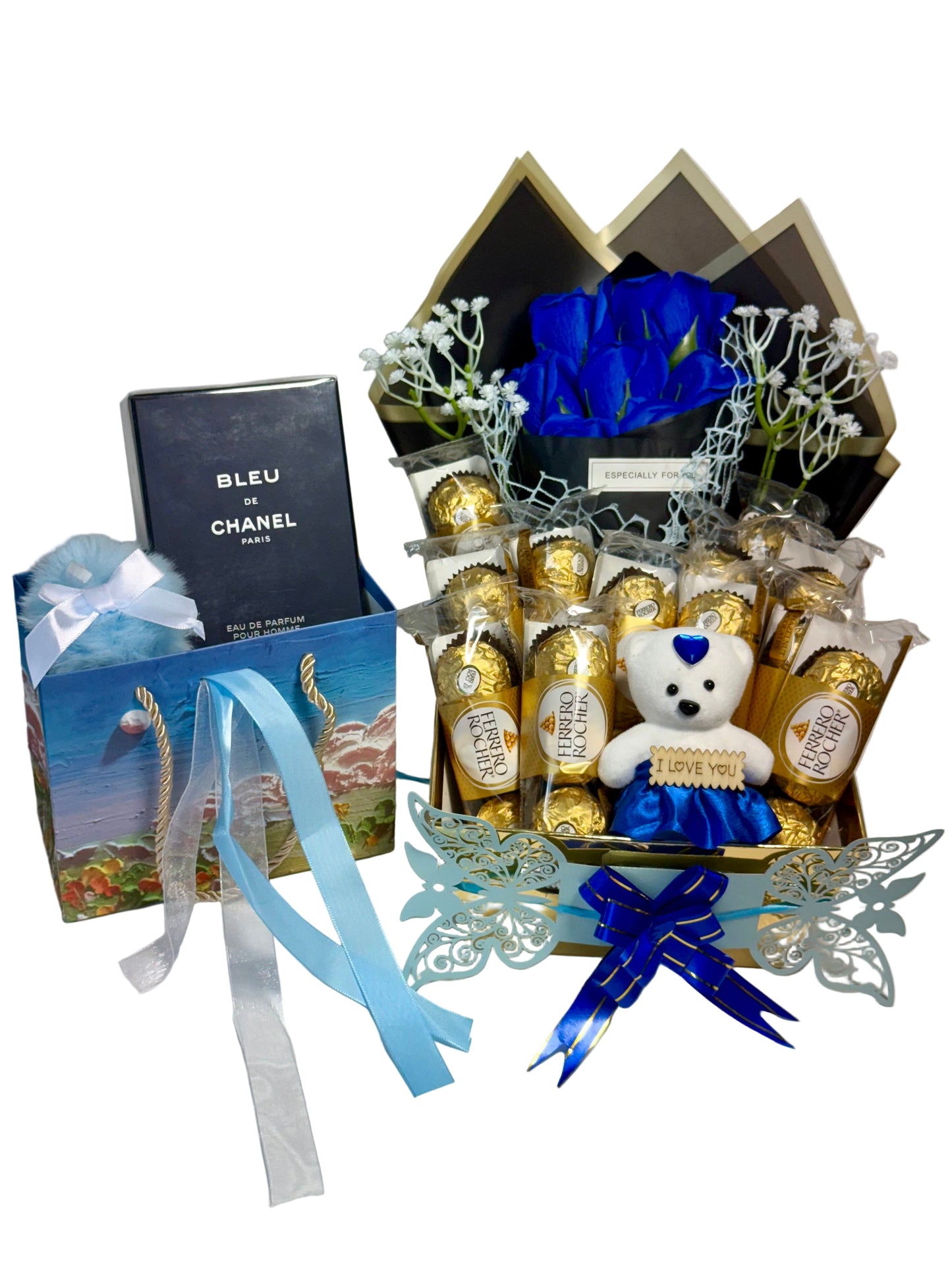 Gourmet gift basket with chocolates, a teddy bear, and a bottle of perfume on a white background
