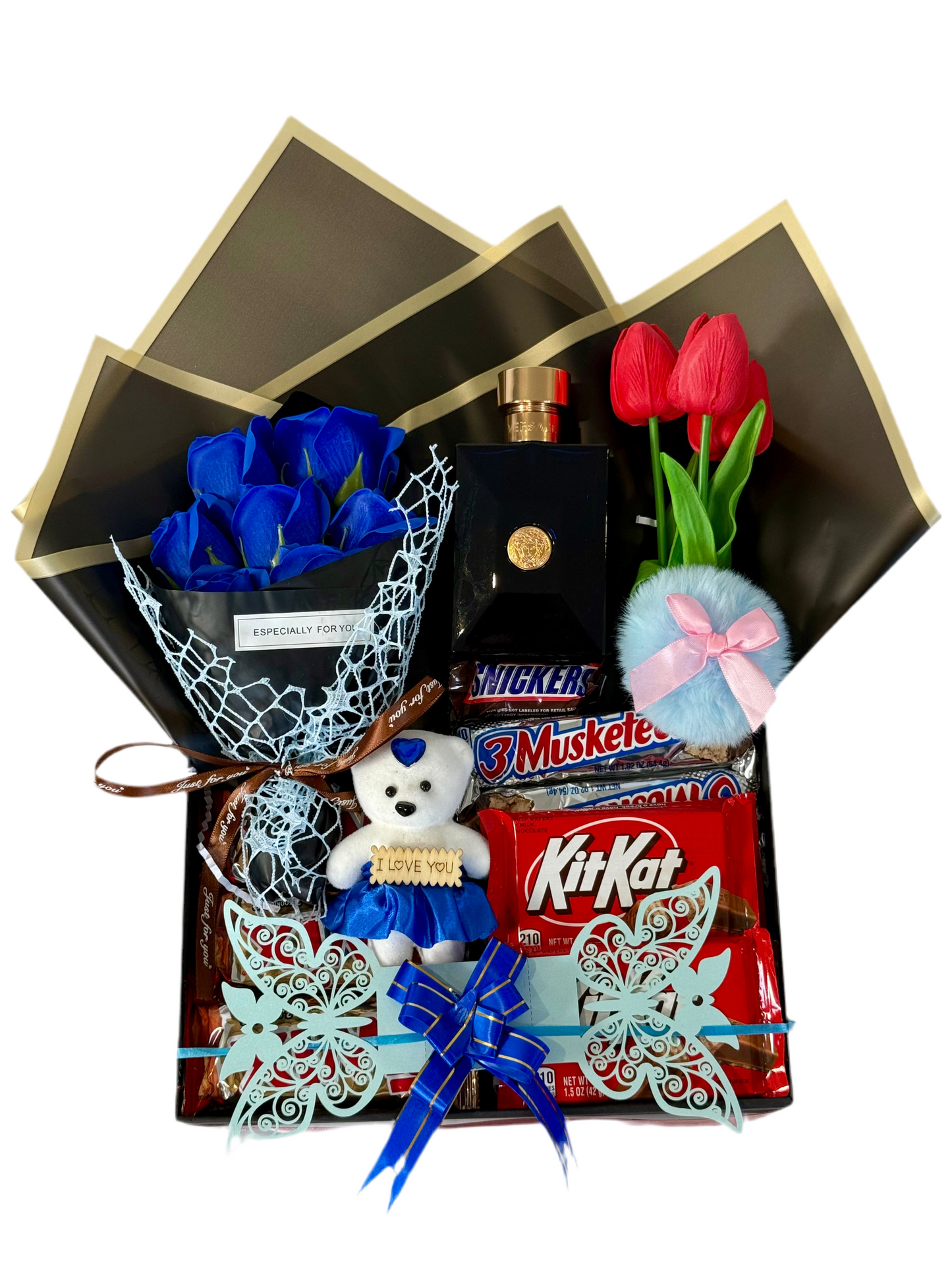Gourmet gift basket with blue roses, teddy bear, KitKat, and other items on a white background