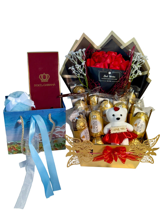 Gift basket with flowers, chocolates, and a teddy bear on a white background