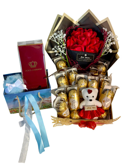 Gourmet chocolate basket with red roses, teddy bear, and gift card on a light background