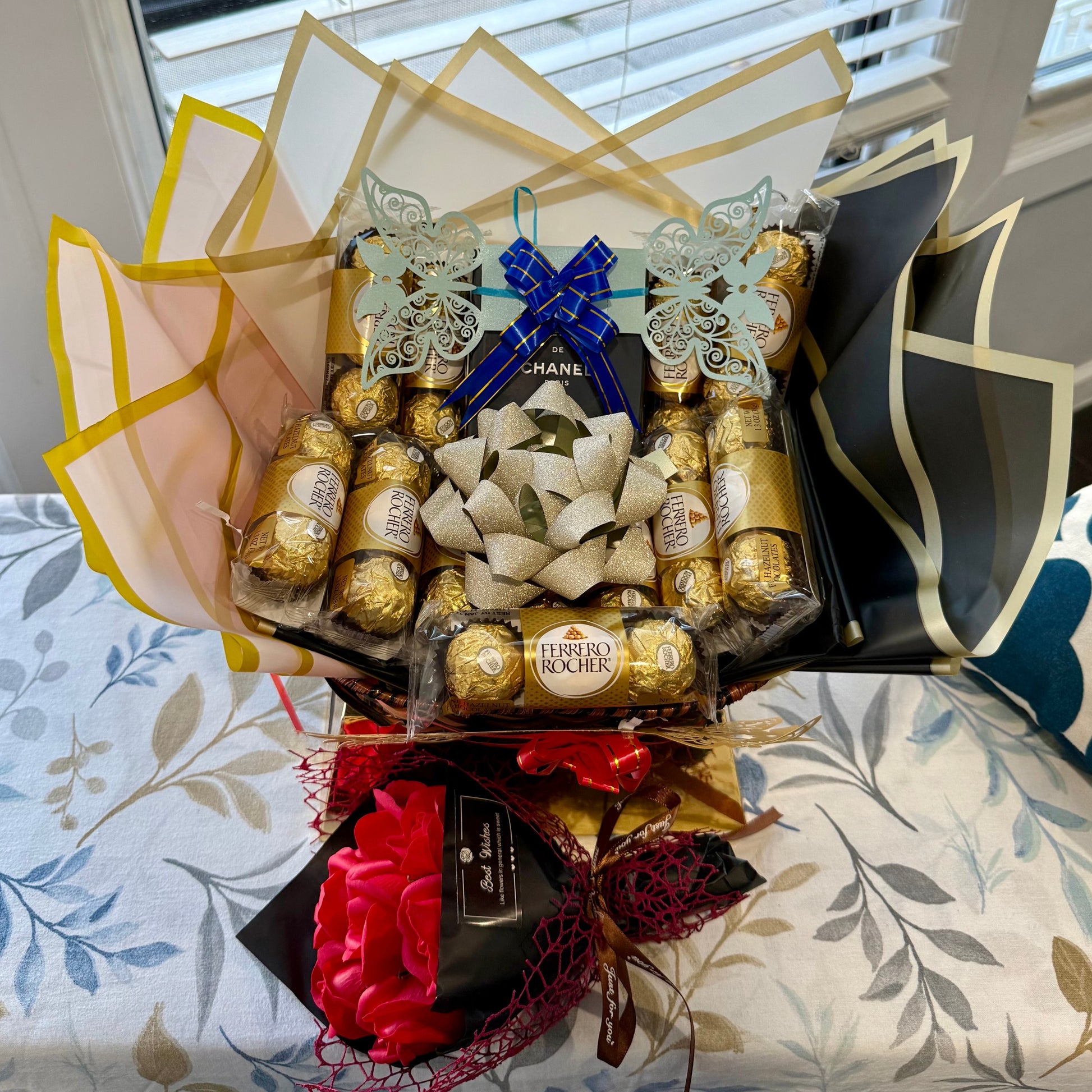 Bouquet of Ferrero Rocher chocolates and flowers on a floral-patterned surface