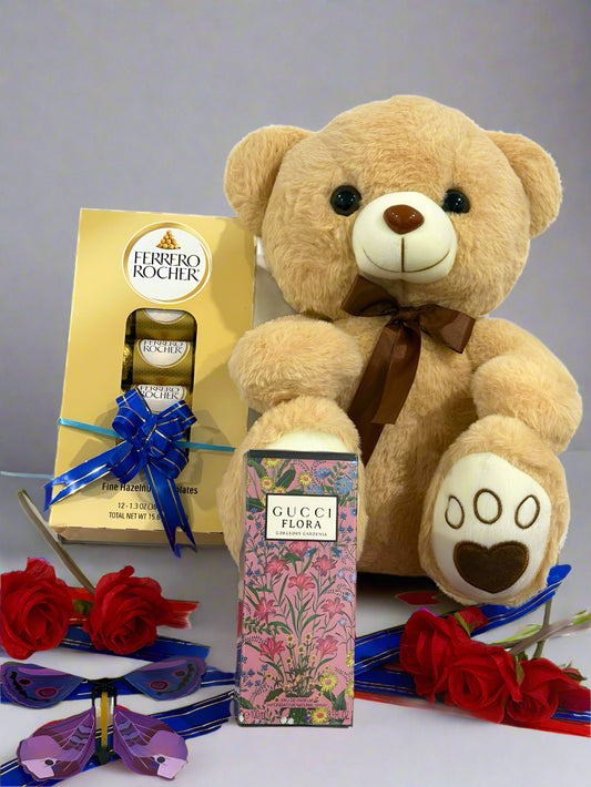 Teddy bear with Gucci perfume, Ferrero Rocher chocolates, and red roses on a white background