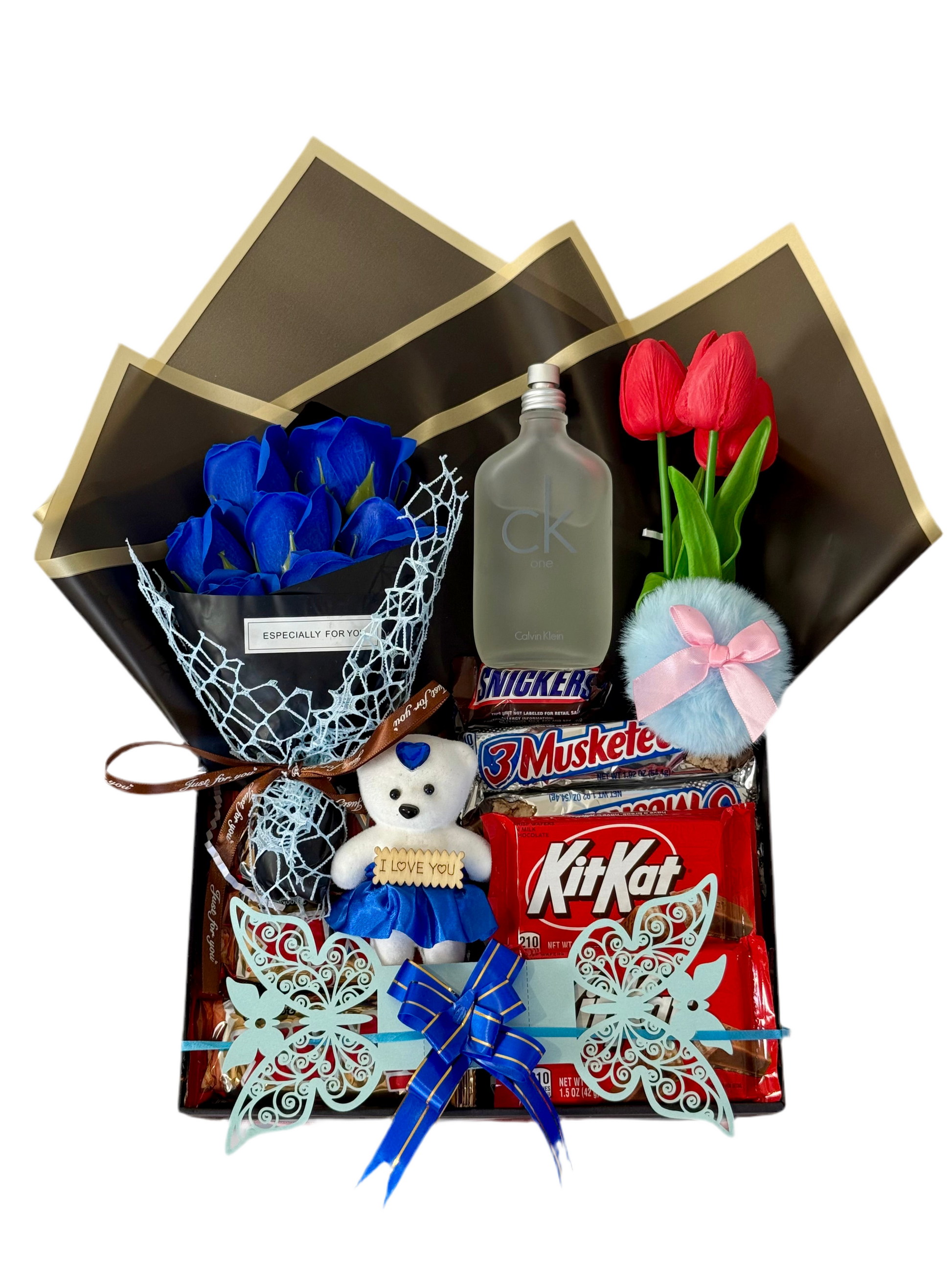 Gift box with blue roses, teddy bear, KitKat, and other items on a white background
