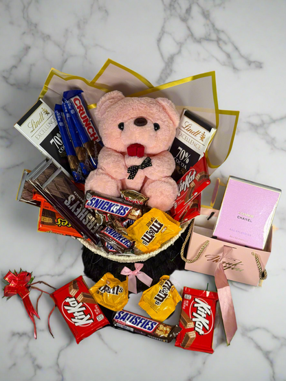Bouquet of candy bars and a teddy bear on a marble surface